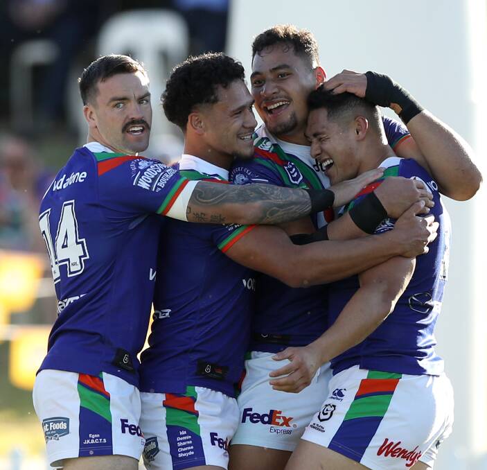 Jubilation: Brilliant Warriors fullback Roger Tuivasa-Sheck is congratulated by teammates after scoring one of his two tries in the side's thumping 36-6 win over the Newcastle Knights in Tamworth. Picture: Getty Images.