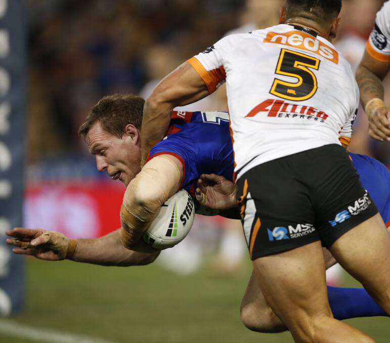 Pivotal: Tim Glasby, a split second before spilling the ball over the line in the first half. The try would have given the Knights an 18-6 lead. Instead, they went into halftime trailing 18-12. Picture: Darren Pateman/AAP. 