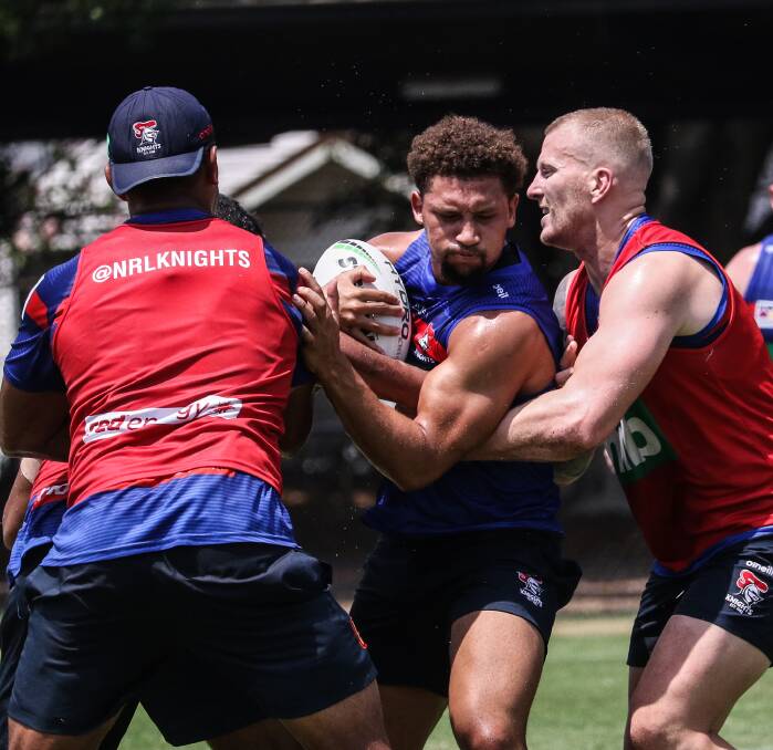 Mixing it: New Knights centre Gehamat Shibasaki is sandwiched in a tackle by Daniel Saifiti and Mitch Barnett at training. Shibasaki is in a battle with Hymel Hunt and Tautau Moga for the right centre position. Picture: Knights media.