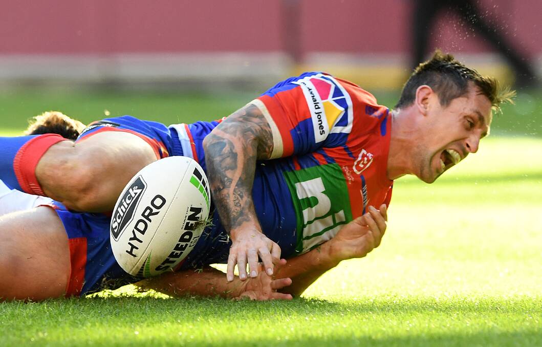 Mitchell Pearce celebrates his try against the Bulldogs..
