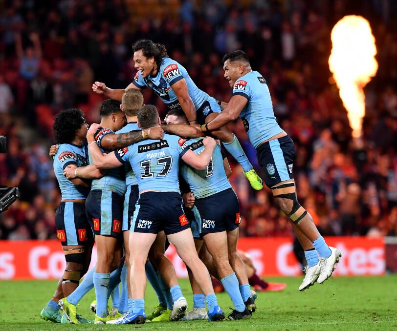 No show: Blues players including Newcastle's Daniel Saifiti celebrate a try. Origin III has been moved from Newcastle to the Gold Coast. Picture: AAP.