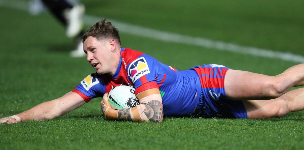 Try time: Knights five-eighth Kurt Mann dives over to score off a Mitchell Pearce pass against the Brisbane Broncos in Gosford. Mann's form in the number 6 jersey this season has proven to be a revelation and he has rewarded coach Adam O'Brien's faith in him. Picture: NRL Photos.