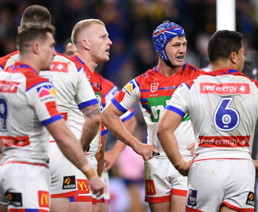 Beaten: Knights players Connor Watson, Mitch Barnett, Kalyn Ponga and Mason Lino showing the strain as the realisation of another defeat paints a gloomy picture at Bankwest Stadium. Picture: AAP. 