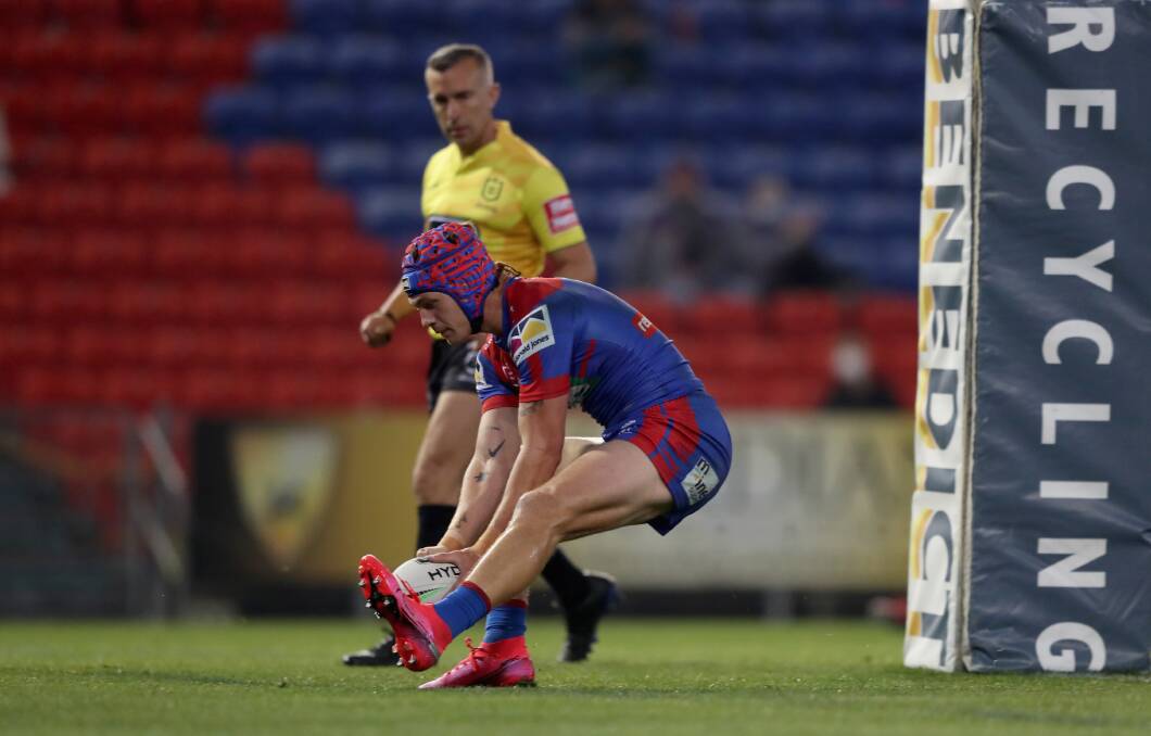 Try time: Knights fullback Kalyn Ponga plants the ball over the line for the first of his two tries in his side's 44-4 demolition of the Wests Tigers at McDonald Jones Stadium on Saturday. Picture: Getty Images.