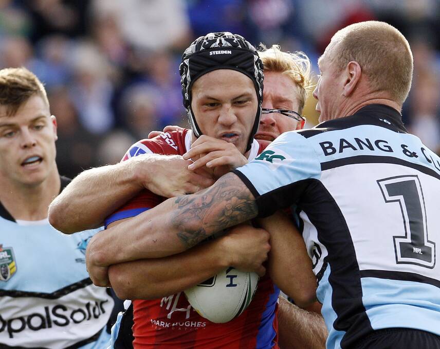 All wrapped up: Knights fullback Kalyn Ponga was well contained by the Cronulla defence during the Sharks' 48-10 win at Beanie for Brain Cancer Stadium. Picture: Darren Pateman/AAP 