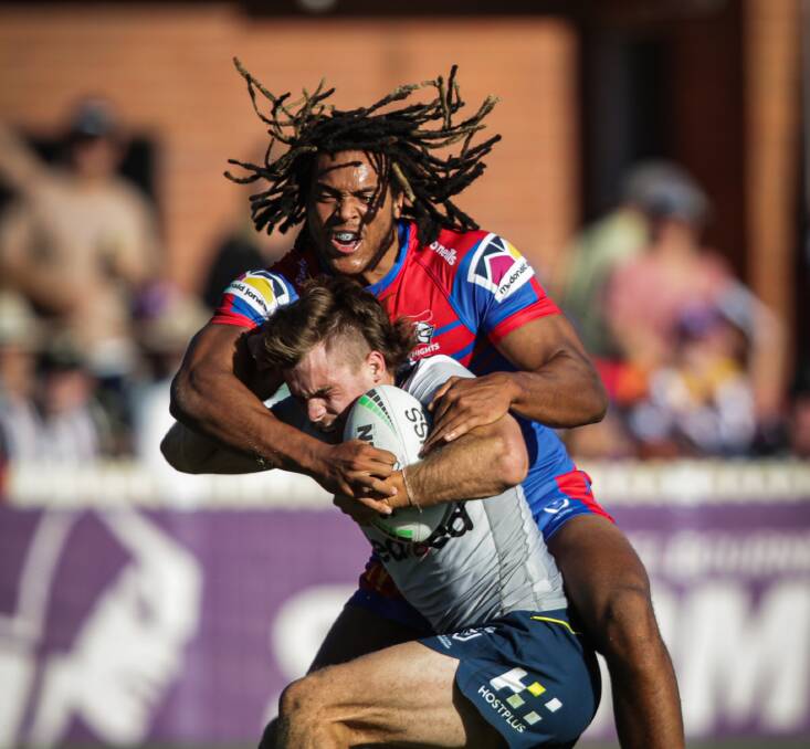 Monstered: New English recruit Dominic Young smothers Storm fullback Ryan Papenhuyzen during the Knights trial loss to Melbourne. Pictures: James Wiltshire.