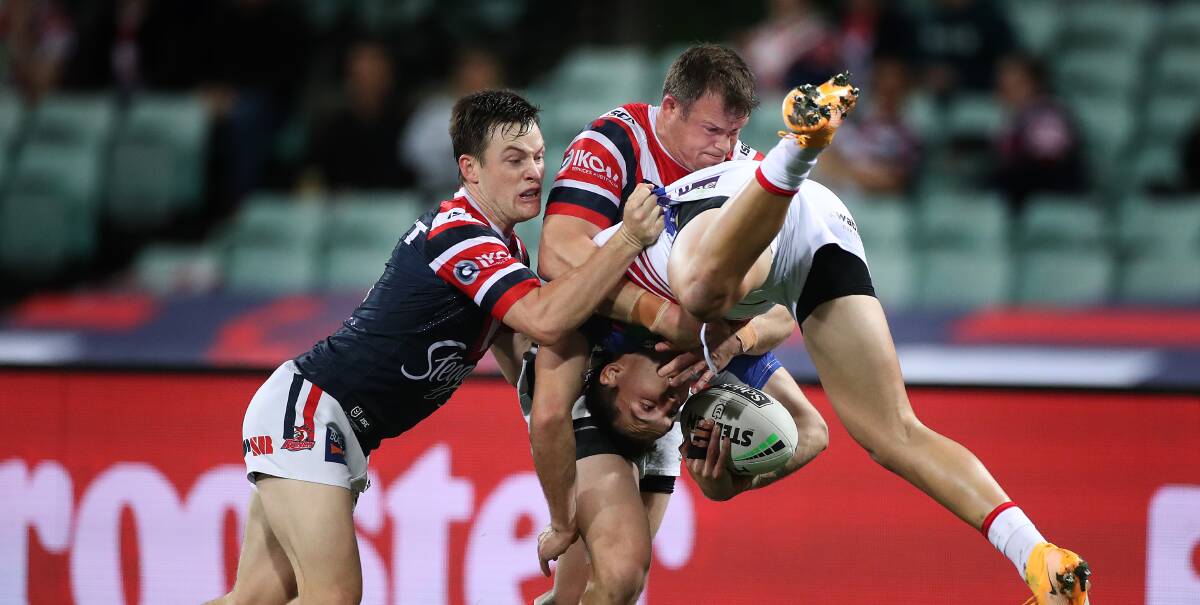 Tex Hoy is upended by Josh Morris and Luke Keary