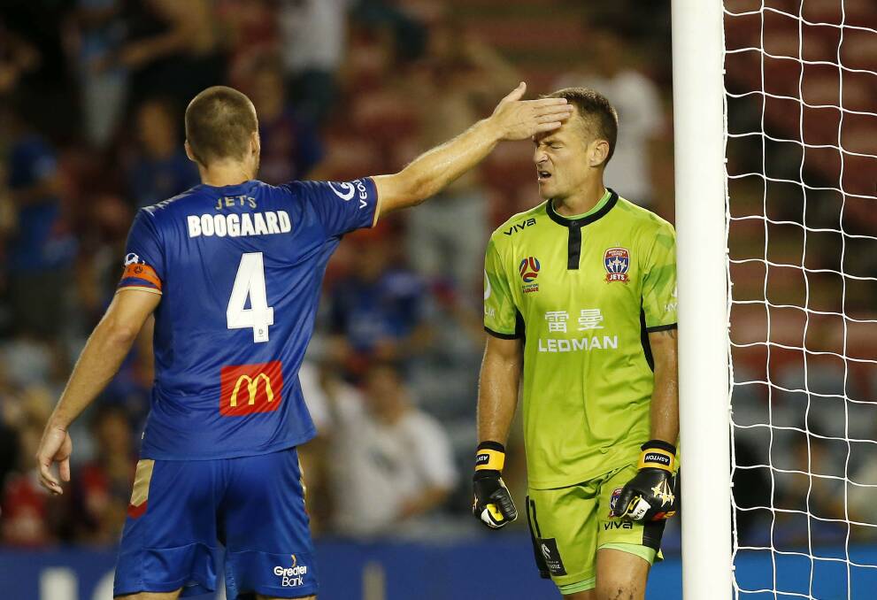 Glen Moss gets a pat on the head from skipper Nigel Boogaard after his penalty save.