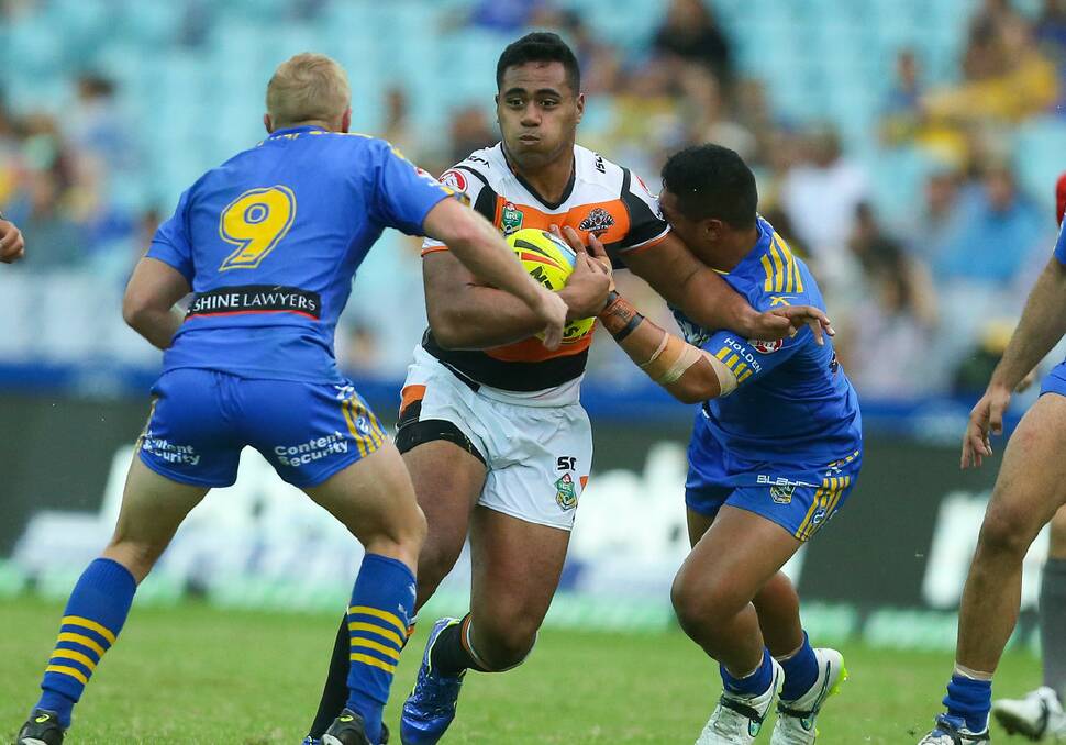 Strong: Prop JJ Felise takes on the Eels defence when he was still at the Wests Tigers prior to his mid-season move to Newcastle.