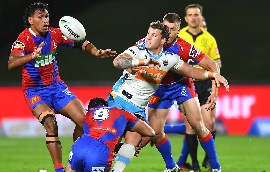 Titans prop Jarrod Wallace gets the ball away against the Knights.