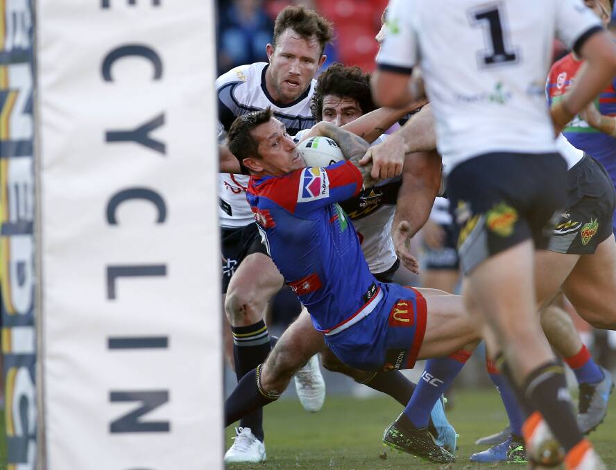 Try time: Knights skipper Mitchell Pearce shows the determination that netted him the second of his two tries for his side in their 42-6 demolition of the North Queensland Cowboys on Saturday. Picture: Darren Pateman/AAP. 