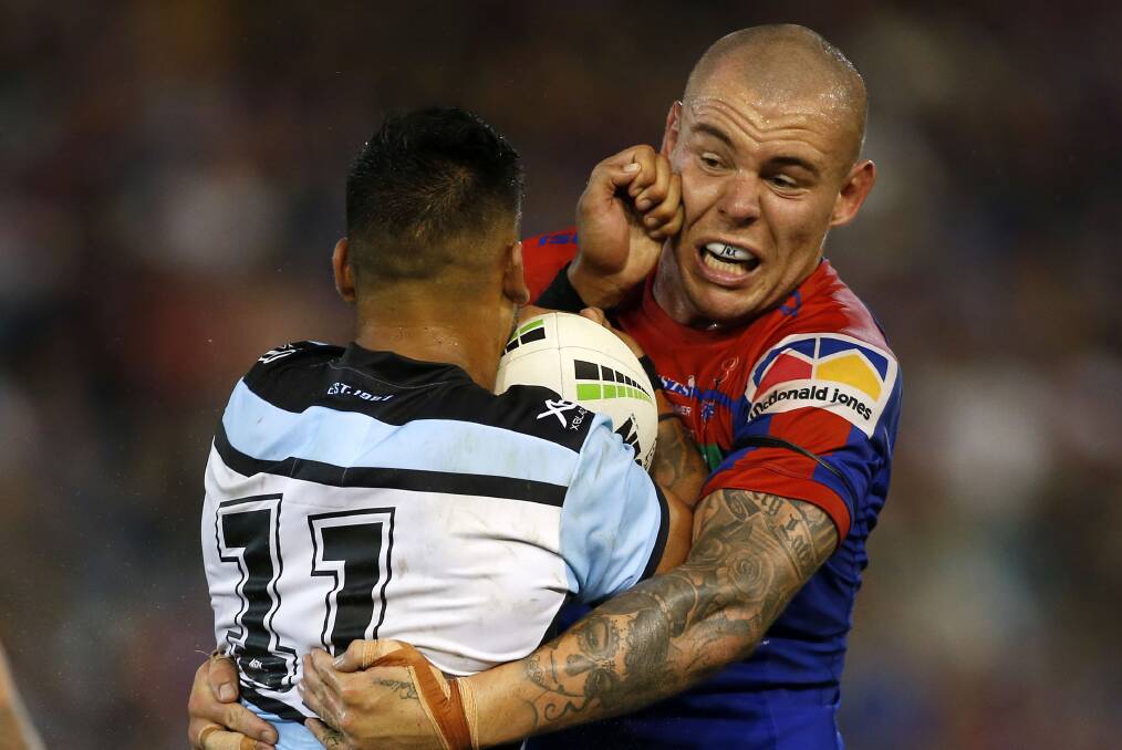 Smothered: Sharks backrower Briton Nikora is man-handled by Knights prop David Klemmer during Newcastle's 14-8 win.
