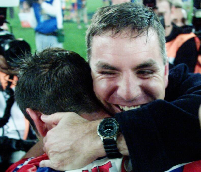Michael Hagan hugs Andrew Johns after the 2001 grandfinal.
