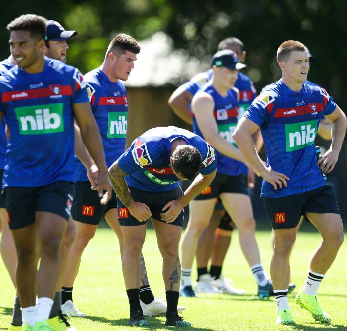 Tough: Knights players including skipper Mitchell Pearce [centre] feeling the pinch during a taxing pre-season training session at the club's Mayfield headquarters. Picture: Jonathan Carroll.