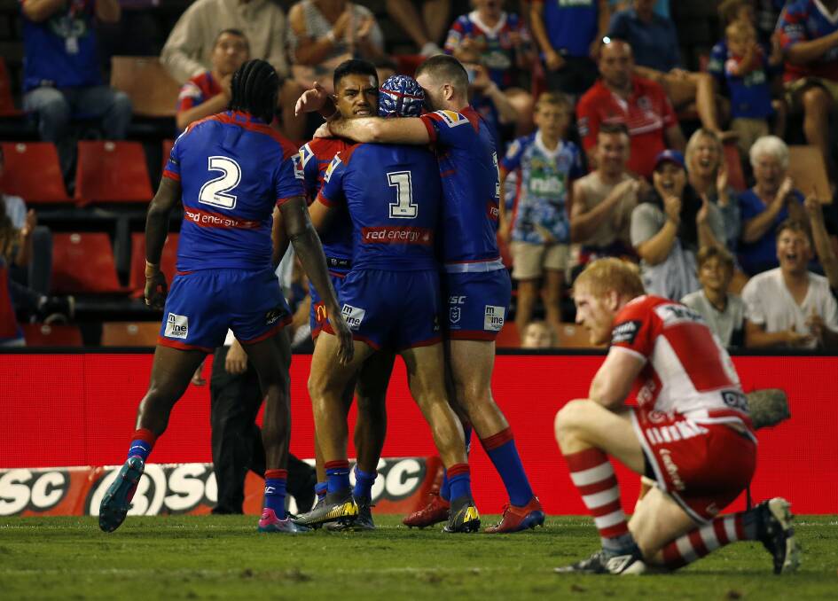 Try time: Knights fullback Kalyn Ponga congratulates centre Hymel Hunt after his first half try against the Dragons. Picture: Darren Pateman/AAP. 