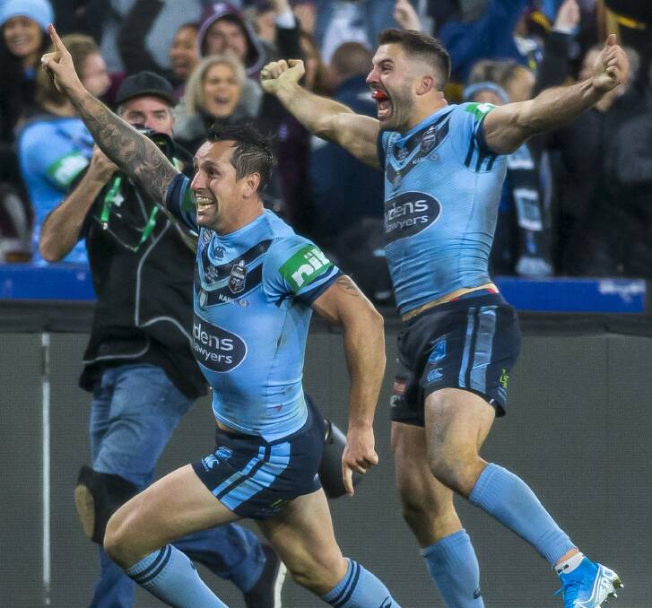 Mitchell Pearce and James Tedesco celebrate.