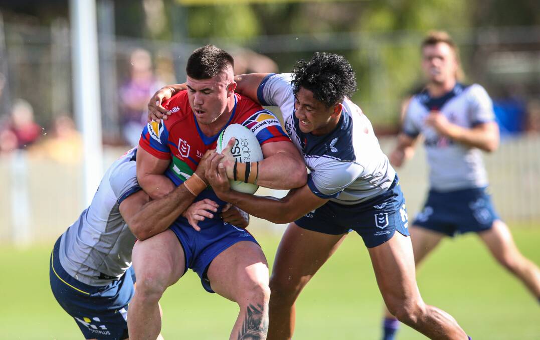 Knights centre Bradman Best is collared by the Melbourne defence on Saturday. Picture: James Wiltshire.