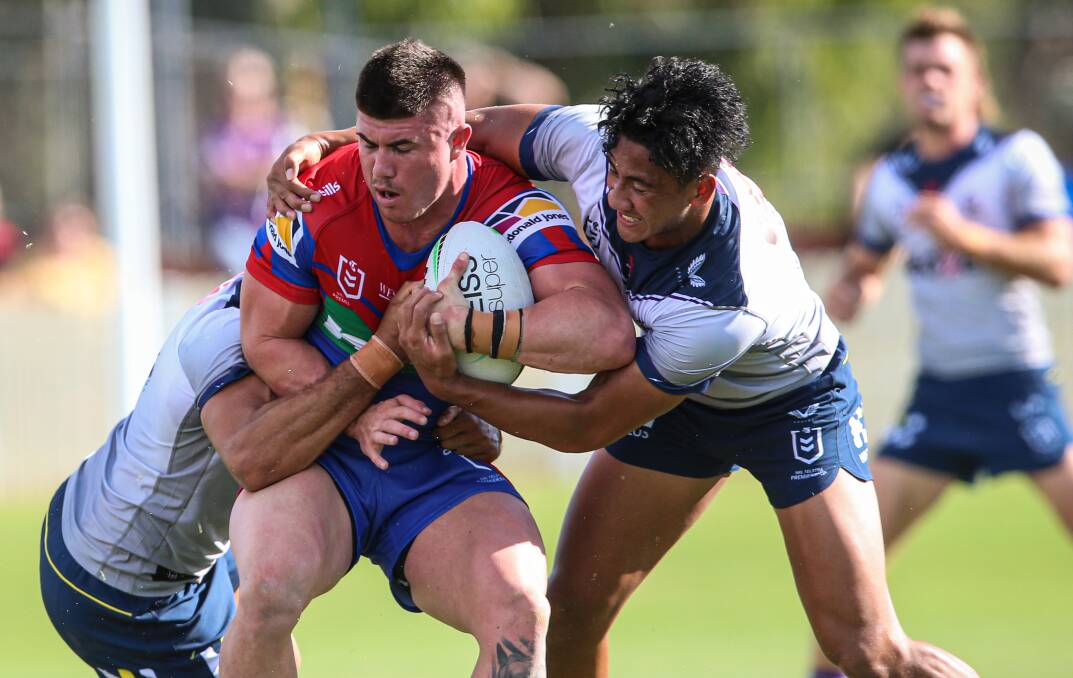 Wrapped up: Knights centre Bradman Best is caught in a two-man Storm tackle during his side's 30-10 trial defeat in Albury on Saturday. 