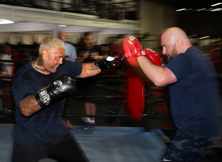 Focused: Mark Hunt pounds the mitts of Newcastle trainer Rob Fogarty during a session at Newcastle's Steel City boxing gym in Hamilton. Picture: Jonathan Carroll.