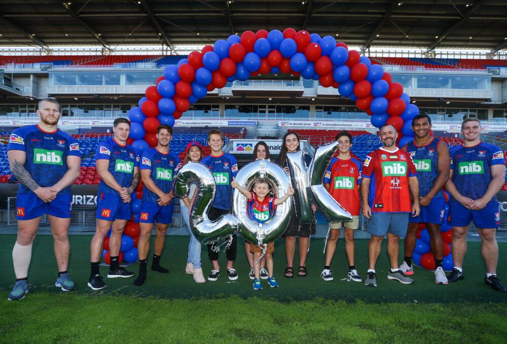 Knights players and fans celebrate the club's membership milestone. Picture: Jonathan Carroll.