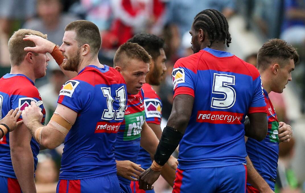 Four pointer: Knights hooker Chris Randall [centre] surrounded by teammates after scoring.
