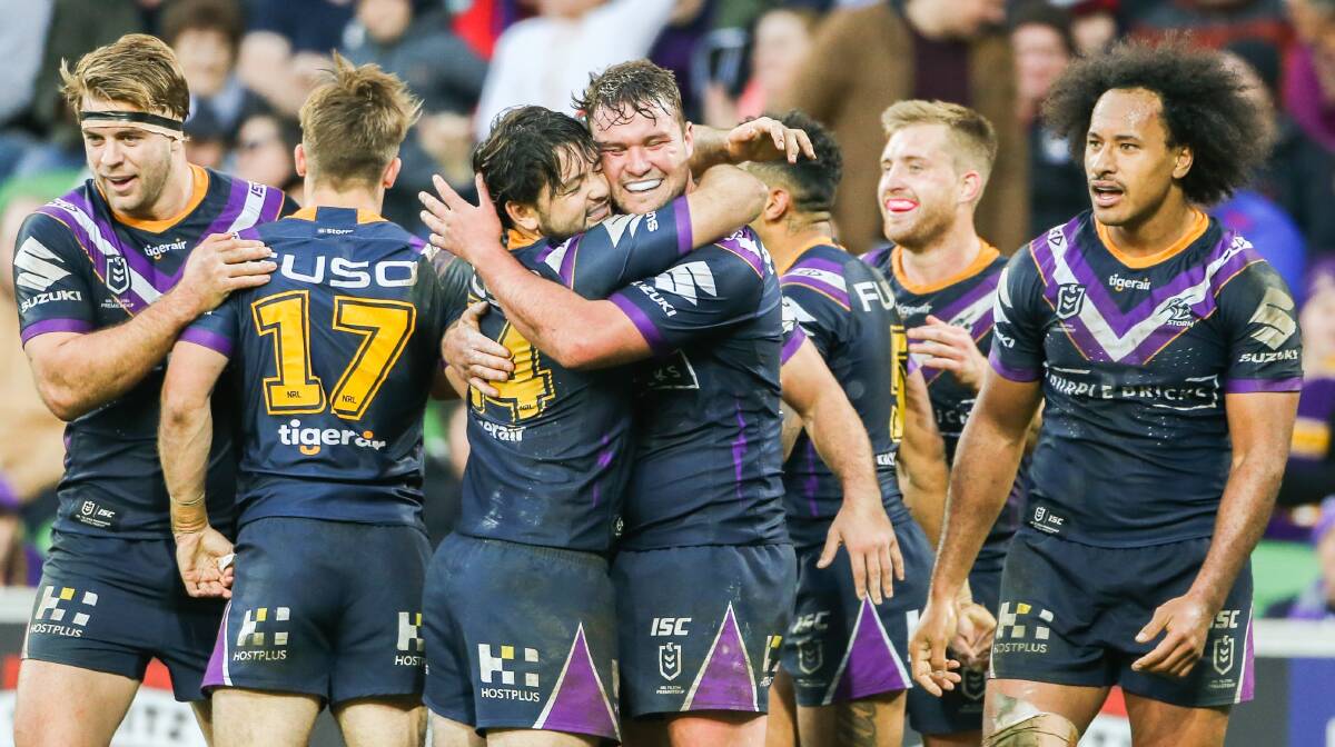 Another try: Melbourne Storm players celebrate after scoring again in their 34-4 rout that ended the Knights' six-game winning streak last season at AAMI Park in Melbourne. Picture: NRL Photos.