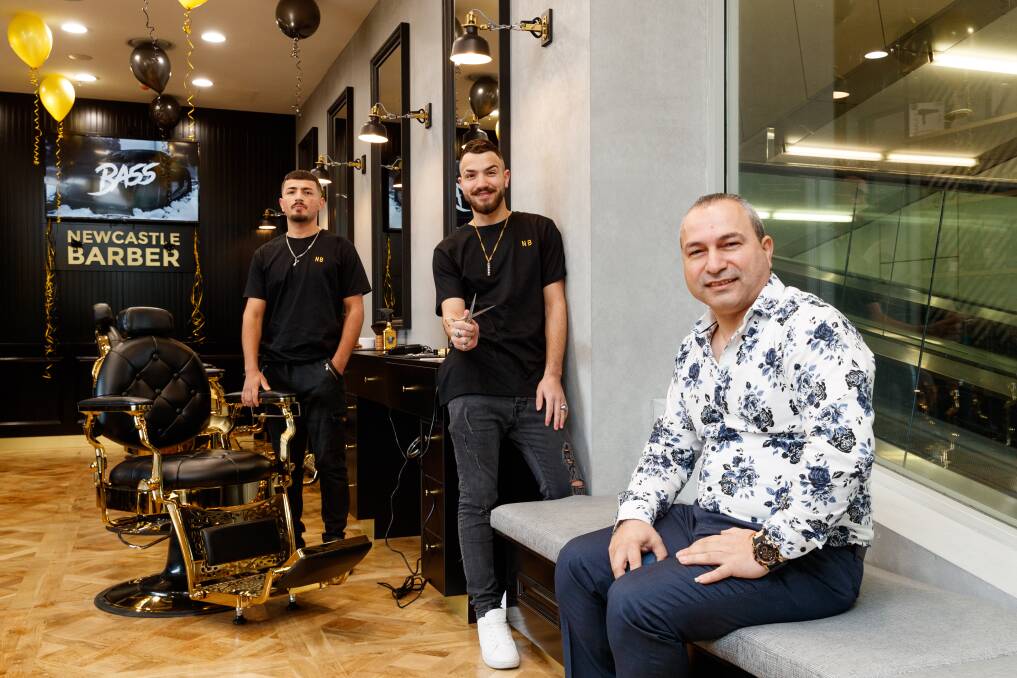 All in the family: Darwich Sido, seated, with sons Mohamad and Khalil, at their Newcastle West barber. Picture: Max Mason-Hubers