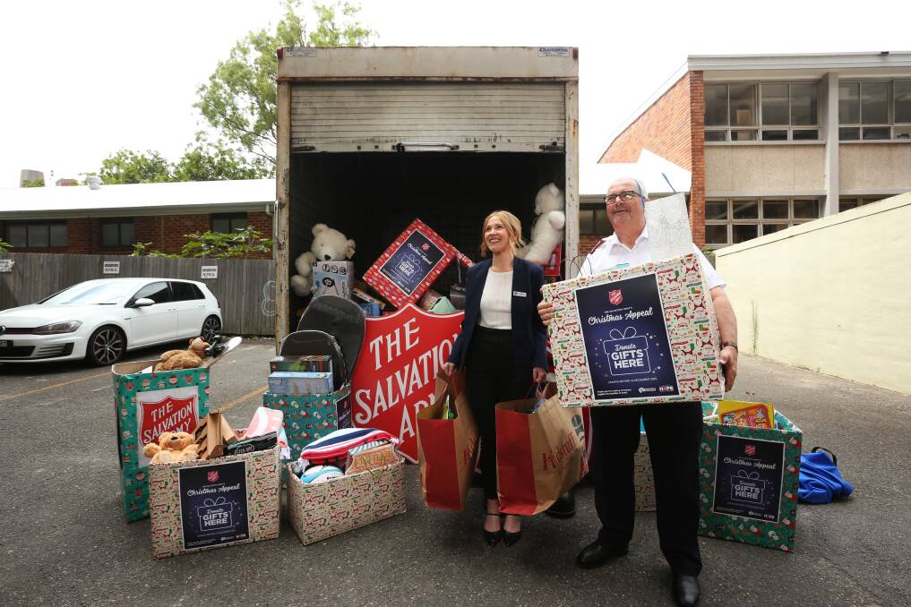 Major Mark Everitt, Salvation Army Area Officer Hunter and Central Coast with Kirsten Lyndon, Newcastle Permanent Partnerships and Community Engagement Manager, packing up the Christmas toys at the Perm's head office in Newcastle on Tuesday. Picture by Simone De Peak