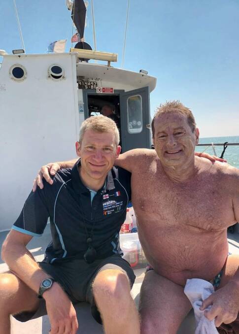 Sweet success: Craig Clarke has a well-earned rest with his main support person, Nils, on board the Pathfinder. 