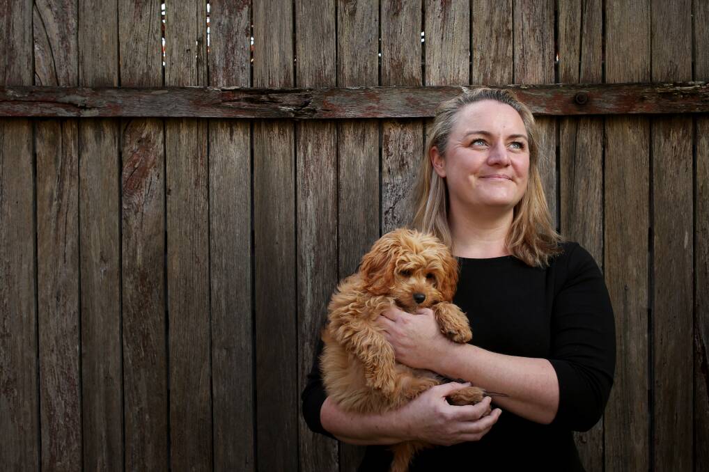 Clarity: When my [ADHD] diagnosis was confirmed it was an an enlightening moment as it explained so many of my idiosyncrasies and struggles throughout my life," says Claire Flynn, with her puppy Peggy at home. Picture: Simone De Peak