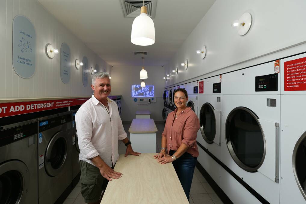 Set the love cycle: Stuart and wife Kersti Faulkner in the Kotara operation of Tumble Club, their new laundromat business. Picture: Jonathan Carroll