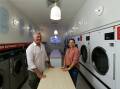 Set the love cycle: Stuart and wife Kersti Faulkner in the Kotara operation of Tumble Club, their new laundromat business. Picture: Jonathan Carroll