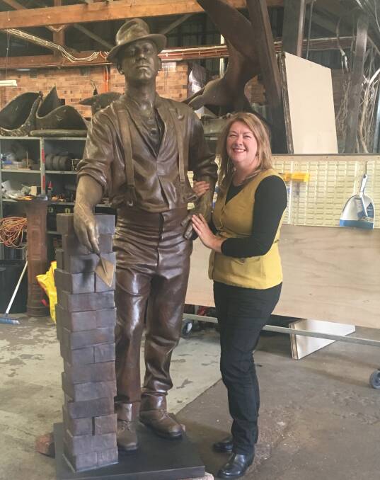 Larger than life: Ms Squires with the bronze sculpture of a brickworker that she  will install at Waratah Village, where Turton and Son's Brick Works once traded. 