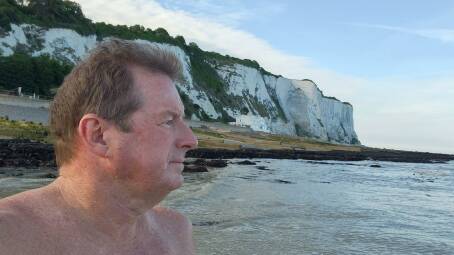 Weather watching: Craig Clarke near the white cliffs of Dover looking across the English Channel. He hopes to swim to Calais as early as July 4. Picture: Supplied