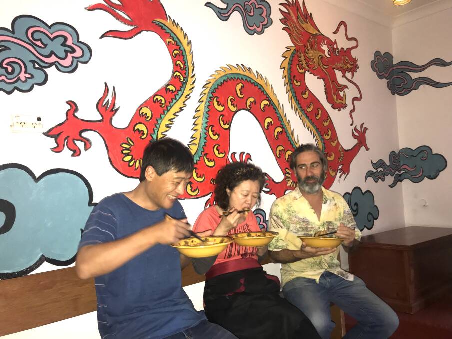 AUTHENTIC EXPERIENCE: Hua “Franky” Fan, with dumpling master Madame Wu and Matt McFarlane with art work by Bridie Watt in the background. Picture: Melinda McMillan