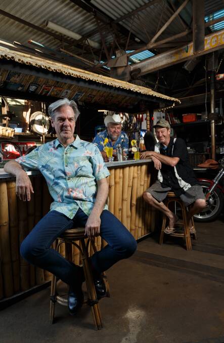 SUNSETS ON BAR: Don Walker, left to right, Roy Payne and Dougie Bull at the tikki bar which has been listed for sale on ebay. Picture: Max Mason-Hubers