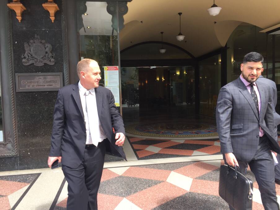 'BUSINESS TRIP': Lemuel Page outside Sydney's Downing Centre courthouse with his lawyer Mahmoud Abbas. The convicted fraudster sought a change in his bail conditions to allow him to travel to Queensland. Picture: Donna Page