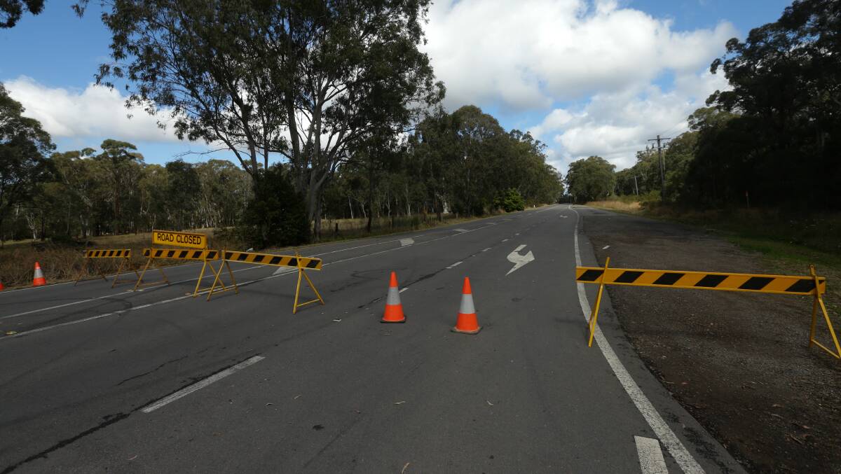 CLOSED: The road was closed and police remained at the scene on Sunday after a body was found wrapped in plastic in Cockle Creek at Killingworth. Picture: JONATHAN CARROLL