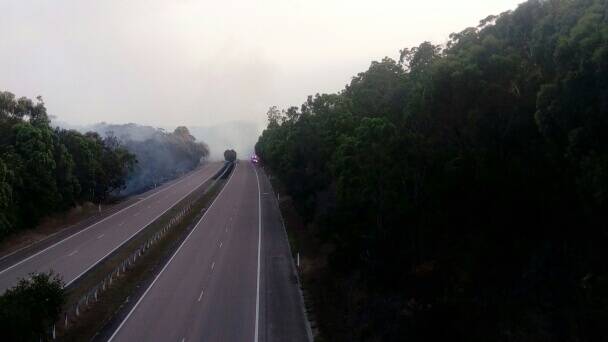 Hazardous: Smoke from a fire blowing across the city bypass on Thursday evening. Picture: Jessica Kellar