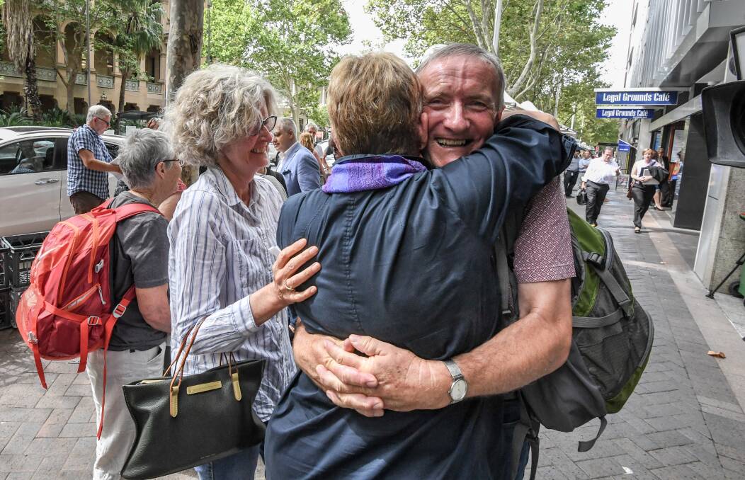 WIN: Anthony Berecry celebrates the landmark decision with fellow Gloucester residents outside the NSW Land and Environment Court in Sydney. 