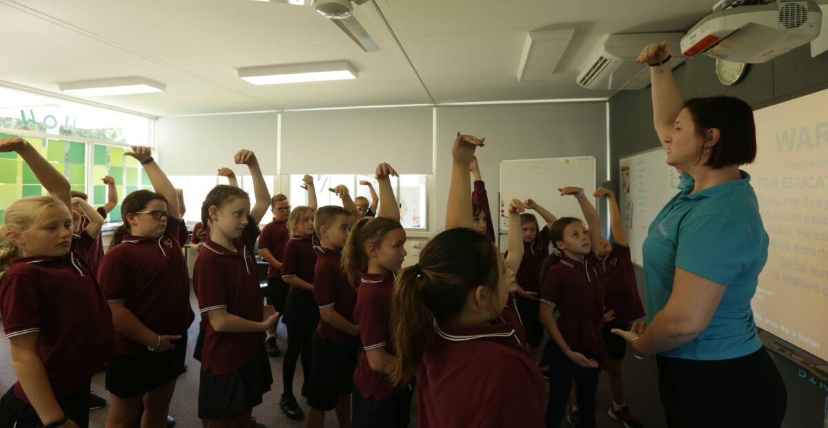 MINDFULNESS: Kylie Humphreys with students during a class mindfulness session at Lochinvar Public School. Picture: Simone De Peak