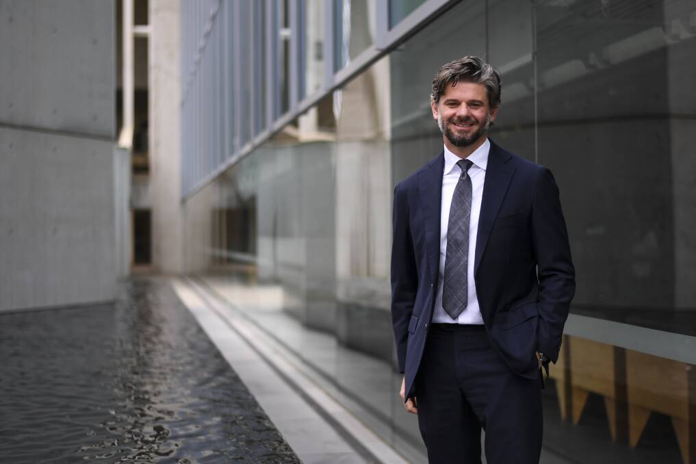 TOP JOB: The incoming director of the National Gallery of Australia, Nick Mitzevich, who grew up in the Hunter Valley, standing outside his new workplace in Canberra.  
