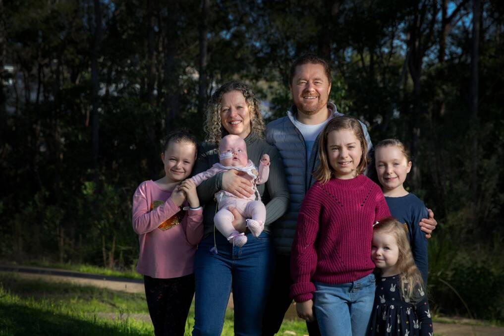 Power of love: Christie and Brad Rea with seven-month-old Imogen, who has spent half her life in hospital, and left to right Summer, 8, Mischa, 12, Breanna, 11, and Catya, 3. Picture: Marina Neil