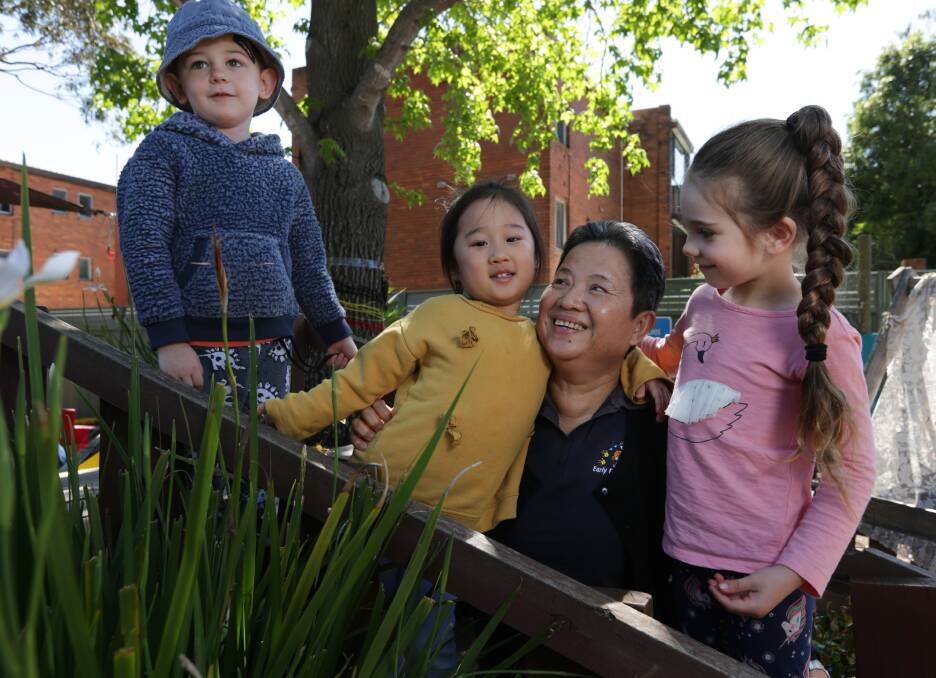 Young at heart: Sophal Sou shares a laugh with Edward, aged four, Amy, aged three and Thea, aged five. Picture: Simone De Peak