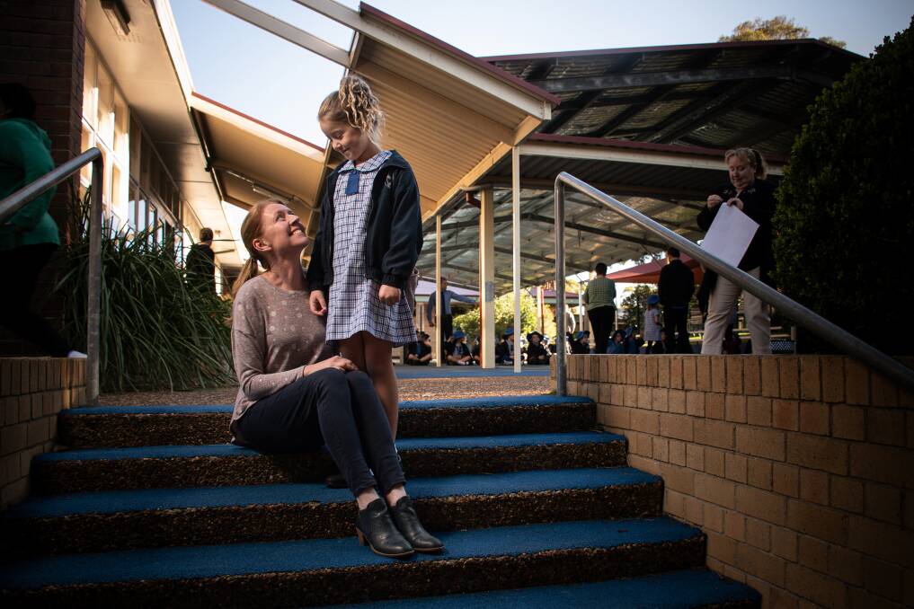 Hopeful: Julie Olischlager, with daughter Sophia, said she felt " a bit unsure [about COVID-19] but I'm trying to be positive - we've got to get on with it, don't we, and stay safe". "I know this school is doing everything possible to keep everyone safe." Pictures: Simon McCarthy. 