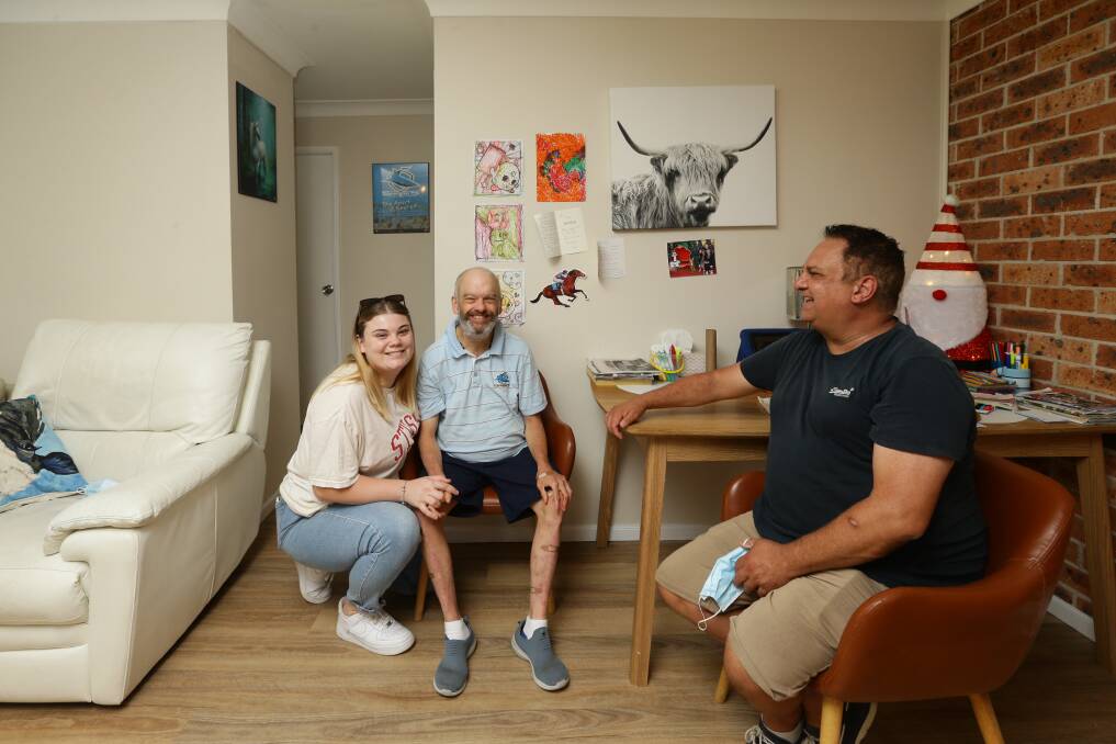 Concerned: Carer Stephanie Pedrana and Paul Millard with Phillipe Millard, who opposes the Christmas Eve closure of the Calvary Mater GP Access clinic. The Belmont and Toronto clinics will have their weekend services halved. Picture: Jonathan Carroll