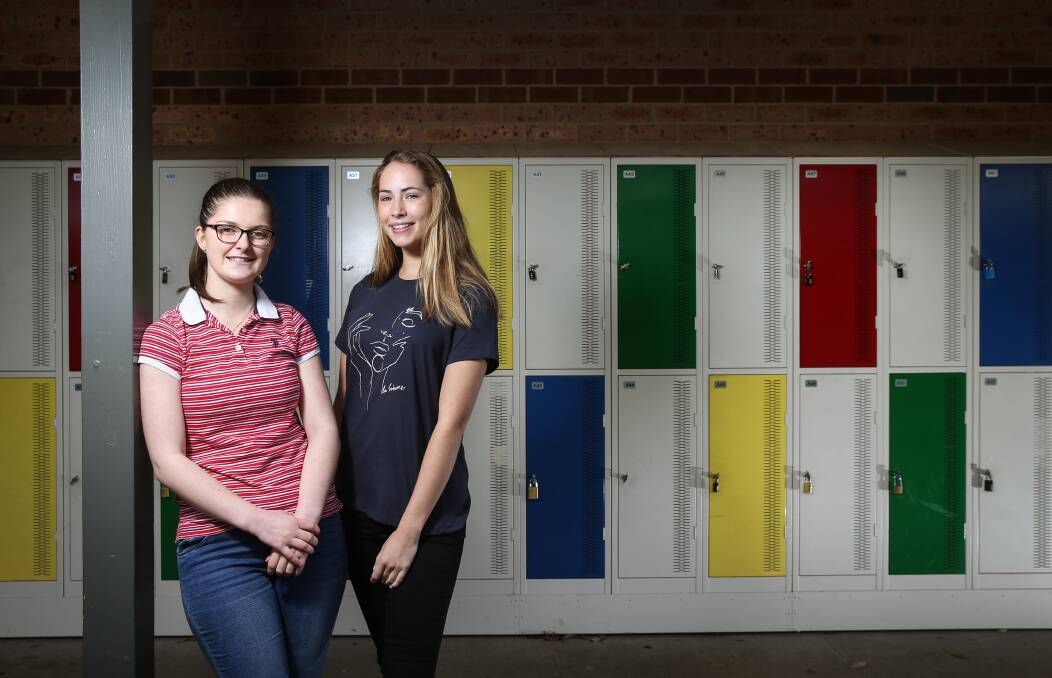 End of an era: Courtney Lawrence and Amelia Lewis said they have mixed feelings about finishing 13 years of schooling. Picture: Marina Neil