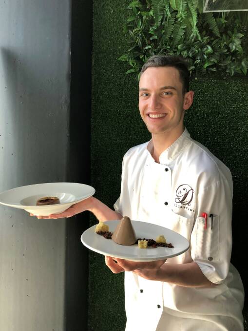Sweet: Jack Mylott holds a plate with milk chocolate and praline panna cotta with vanilla chiffon, roasted coconut, strawberry gelée and praline soil. The bowl has mousse chocolate and praline panna cotta. 