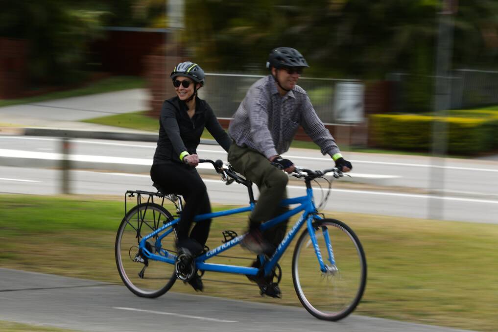 Free-wheeling: Gretchen Jones cycles with pilot Michael Golden. The program aims to provide health and social benefits. Picture: Jonathan Carroll
