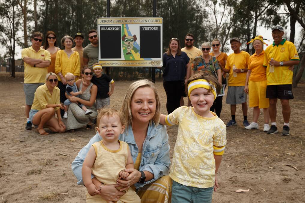 Honour: Jo Brecard with sons Maddox, 1, and Remy, 4, and Jerome Brecard's relatives and friends. His parents Tara and Serge are on the right. Mrs Brecard said he would be "really proud" of his year six class. Picture: Max Mason-Hubers